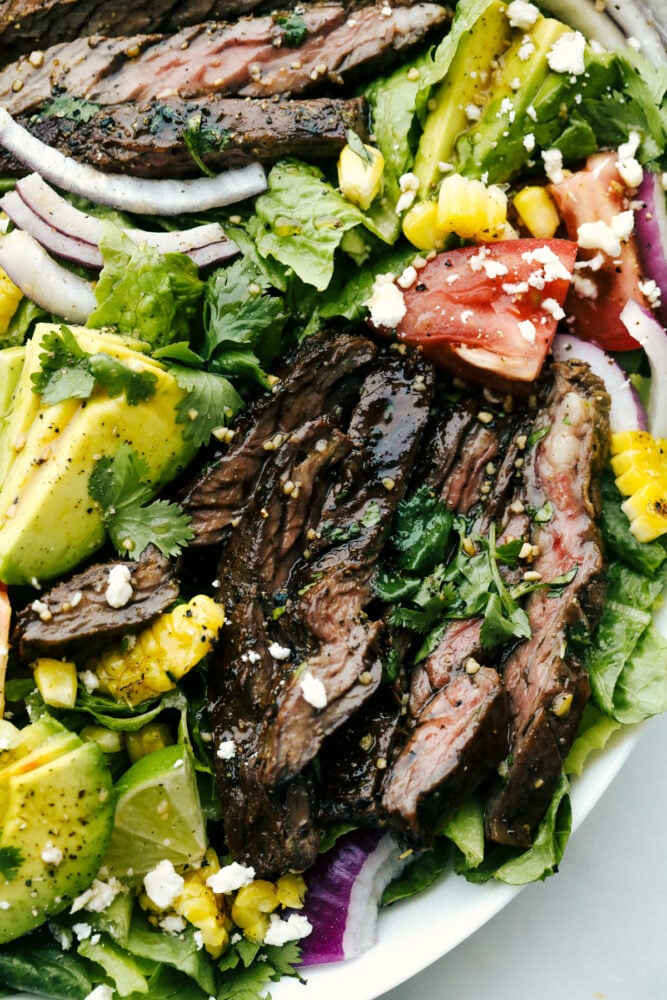 Close-up of steak salad with honey balsamic dressing.