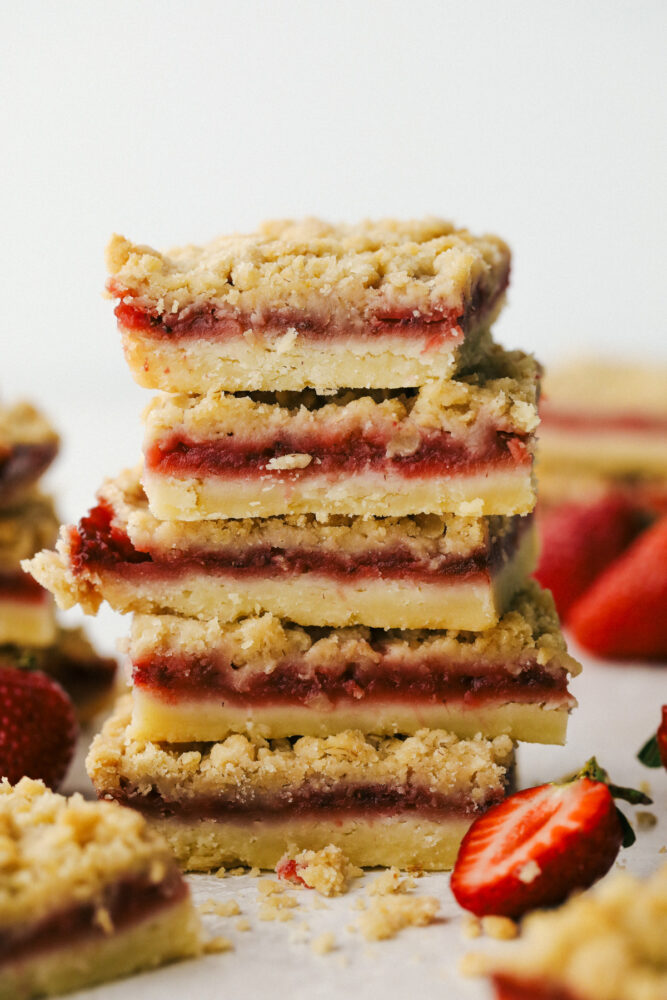 Streusel Strawberry Bars stacked on top of each other ready to eat. 