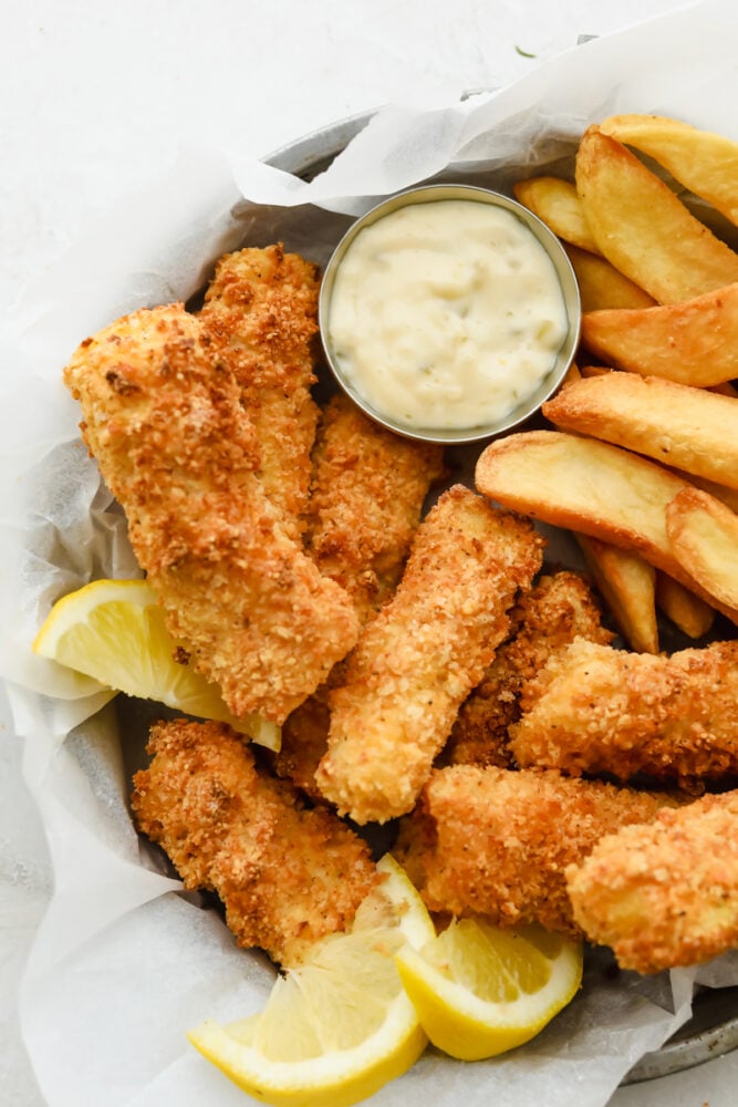 Air fryer fish sticks with french fries and tartar sauce. 