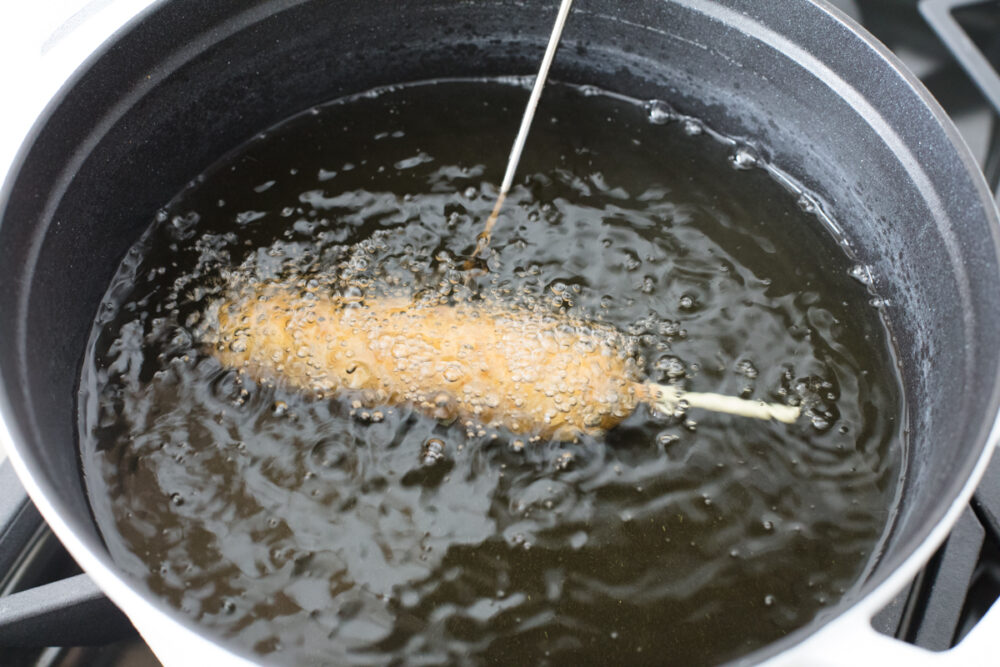Frying the corn dogs. 
