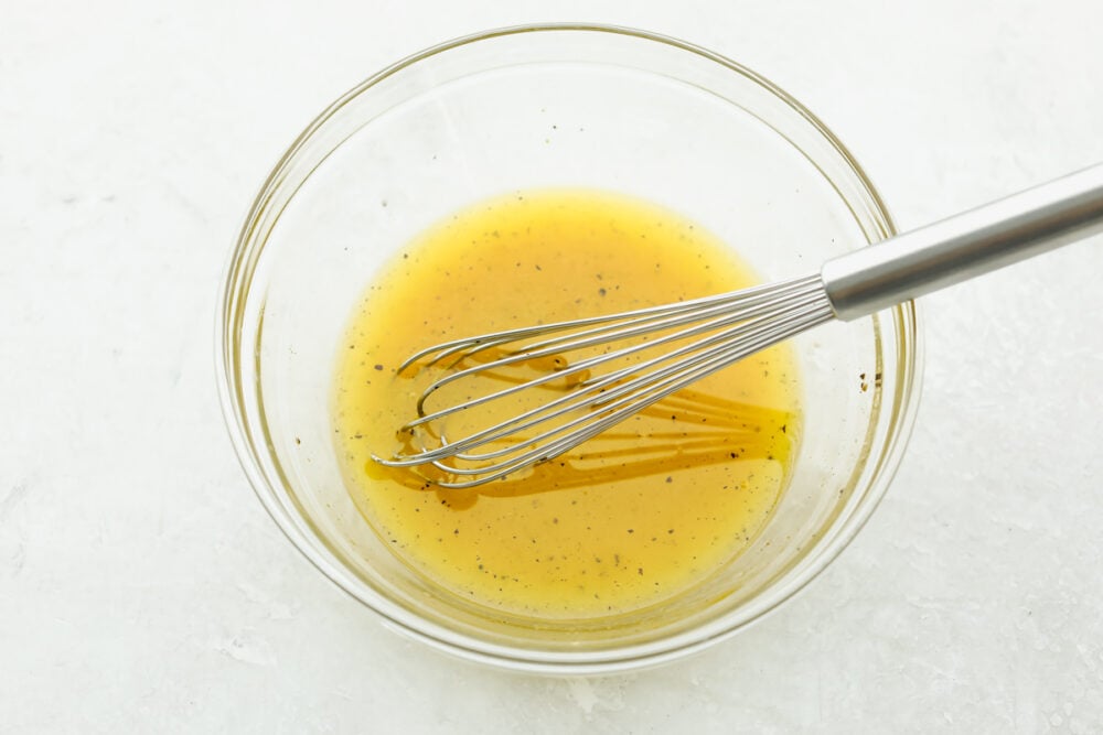 A bowl with the dressing and a whisk. 