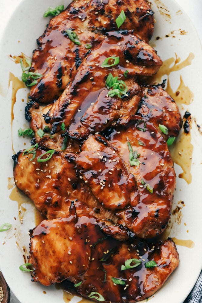 Grilled chicken with teriyaki sauce on a white plate. 