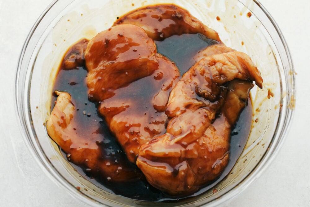 Raw chicken marinating in the teriyaki sauce. 