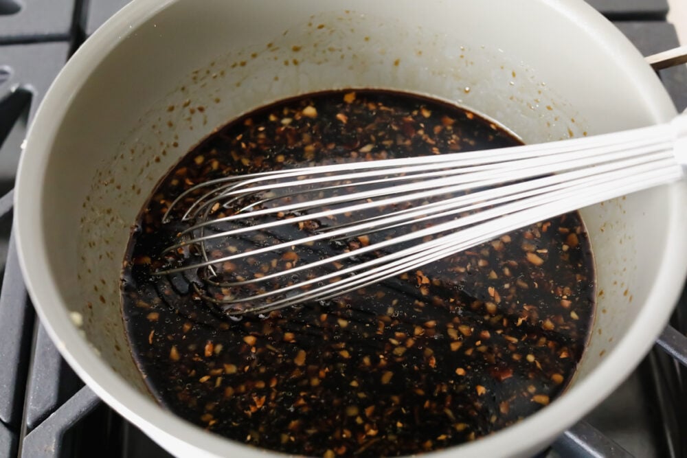 Mixing the ingredients in a saucepan to simmer. 