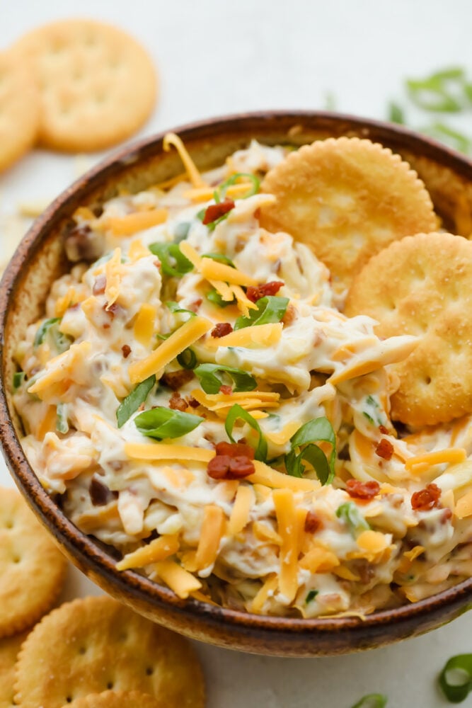 Bowl of million dollar dip with crackers.