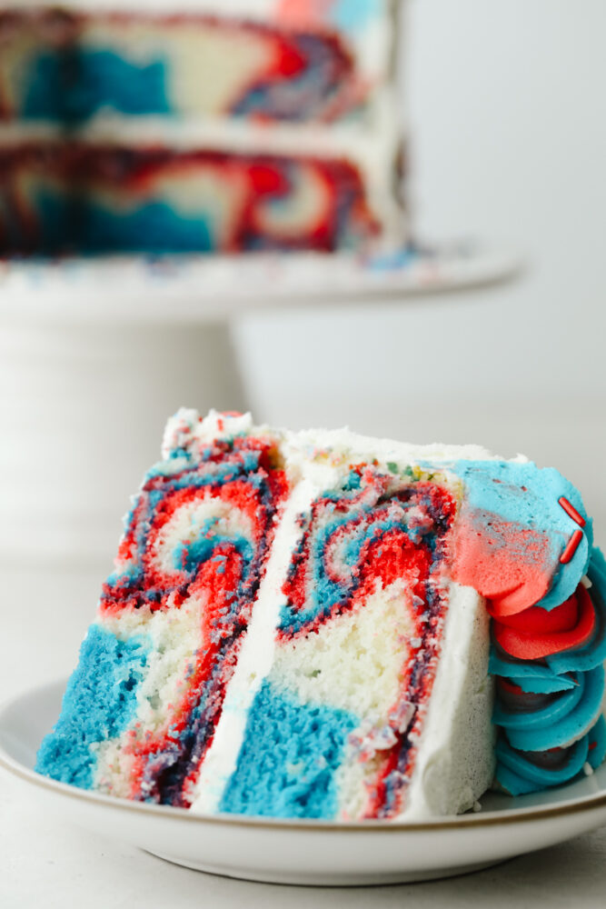 A slice of the red white and blue cake showing the swirls. 