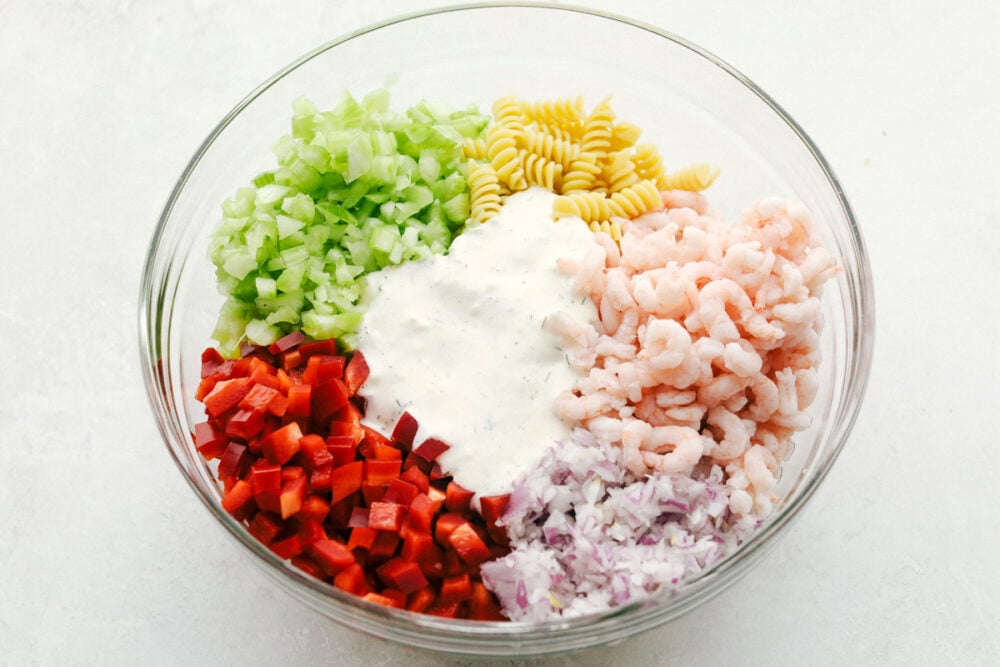 Shrimp pasta salad ingredients in bowl before mixing
