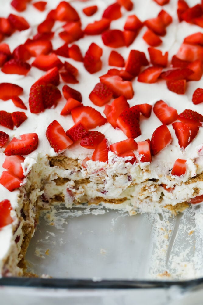 Strawberry icebox cake with piece cut out.