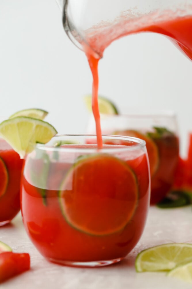 Pouring watermelon agua fresca into glass