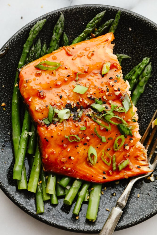 Asian glazed salmon served on top of asparagus.