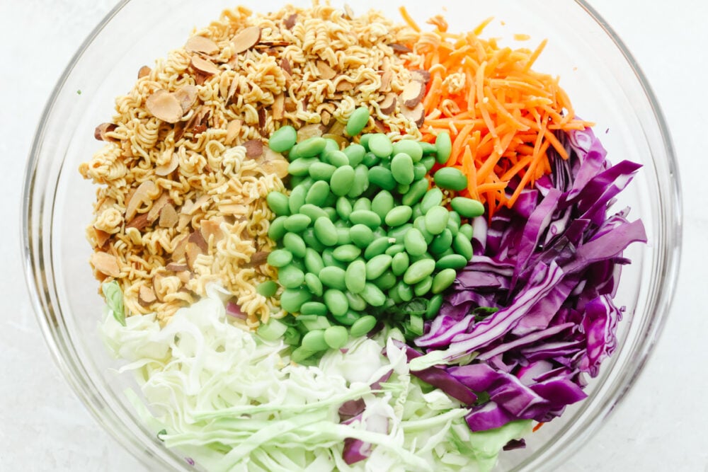 Asian Ramen Salad is full of color, flavor, and crunch! All of the fun textures make it perfectly satisfying and insanely delicious! Ingredients for the salad ready to be mixed.