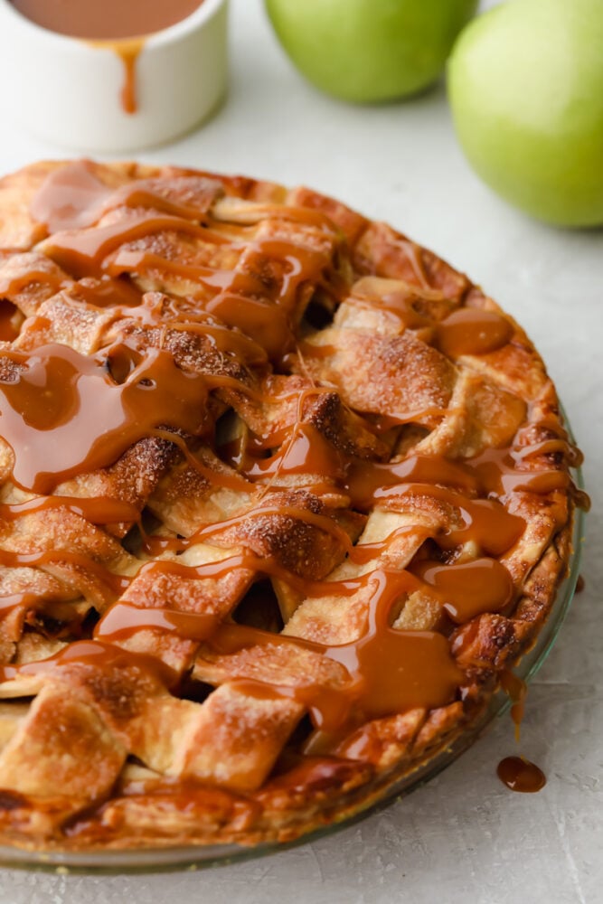 Caramel apple pie with caramel drizzled on top. 
