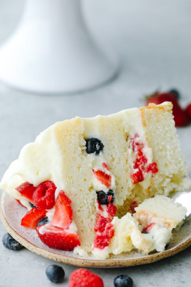 Close up of a slice of Chantilly Berry Cake. 
