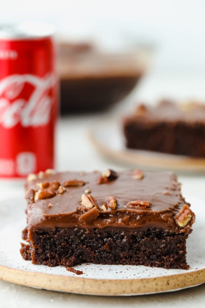 Coca-Cola cake slice covered with nuts.