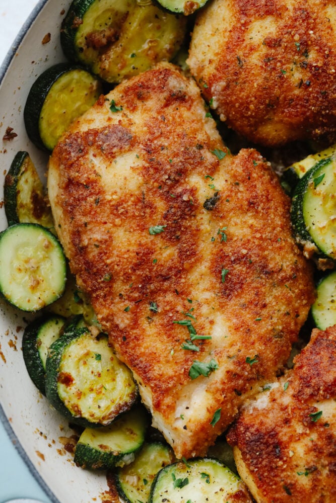 Close-up of crispy parmesan garlic chicken and zucchini.