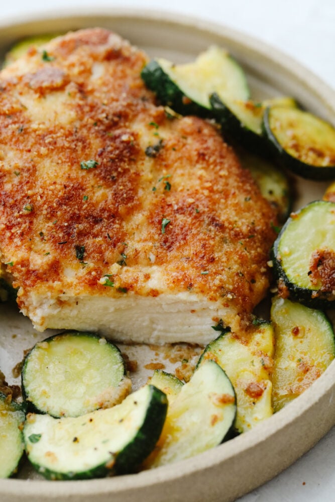 Slice cut out of parmesan garlic chicken with zucchini.