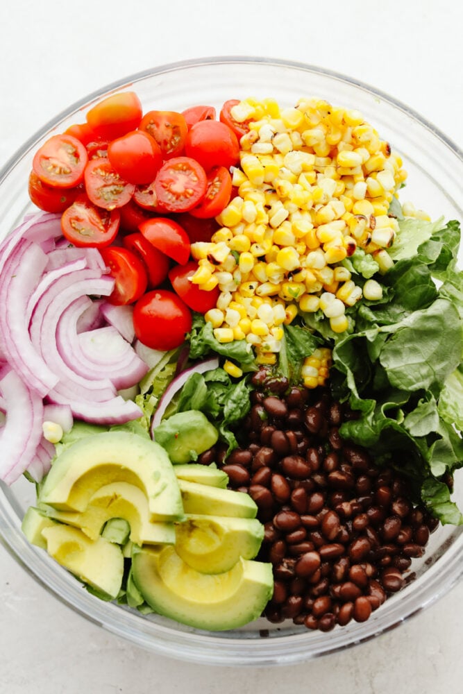 A variety of vegetables and beans ready to be mixed.