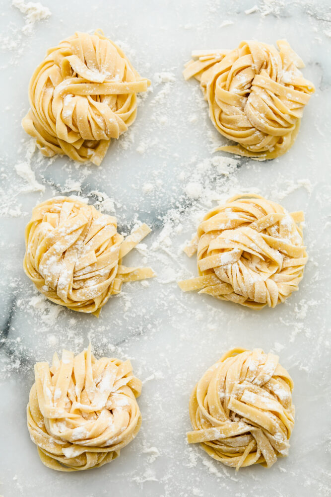 Long strands of noodles in nests ready to cook. 