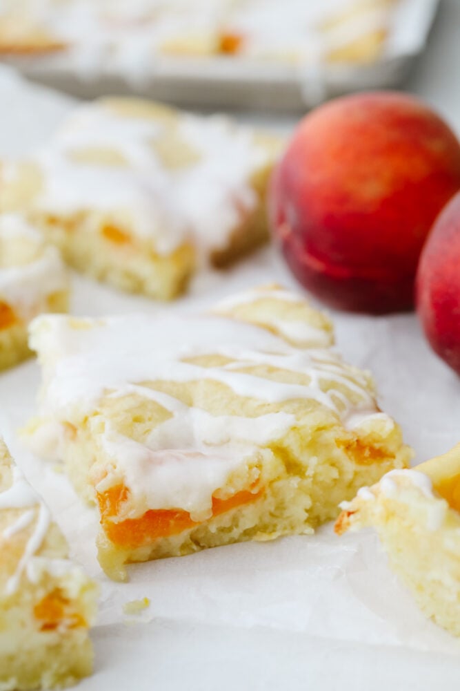 Peaches and cream pie bars on parchment paper.