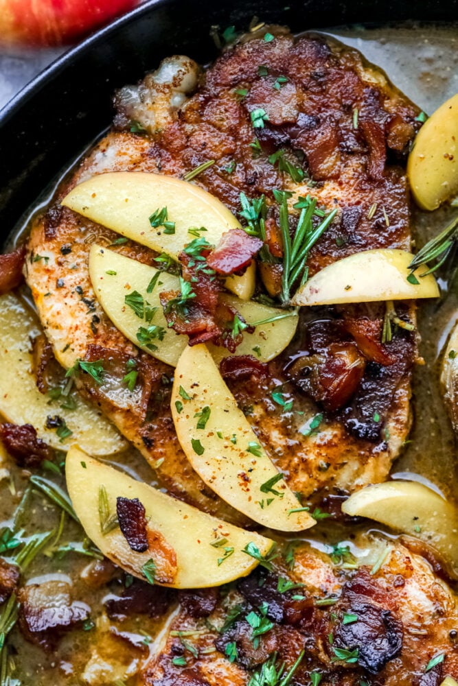 Pork chops with apples in bacon sauce. 