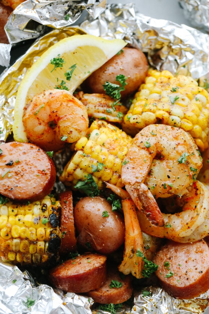 Close-up of Shrimp Boil Foil Packet with lemon garnish.