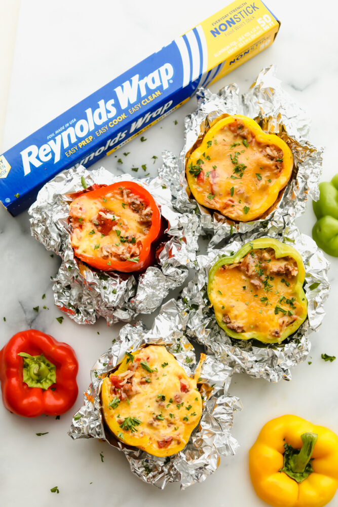 Stuffed bell peppers are filled with lean ground beef, rice, tomatoes, and the perfect blend of seasonings all topped with shredded cheese. Individually wrapped peppers make a colorful and delicious dinner with a beef combination full of flavor. Grilled stuffed bell peppers in the