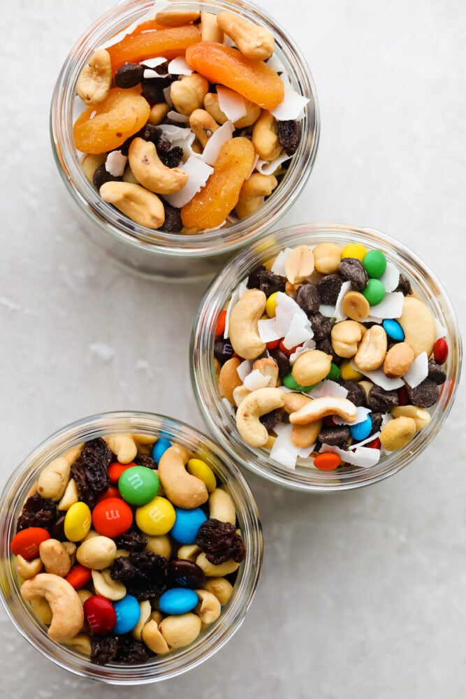 Glass jars filled with all three trail mixes.