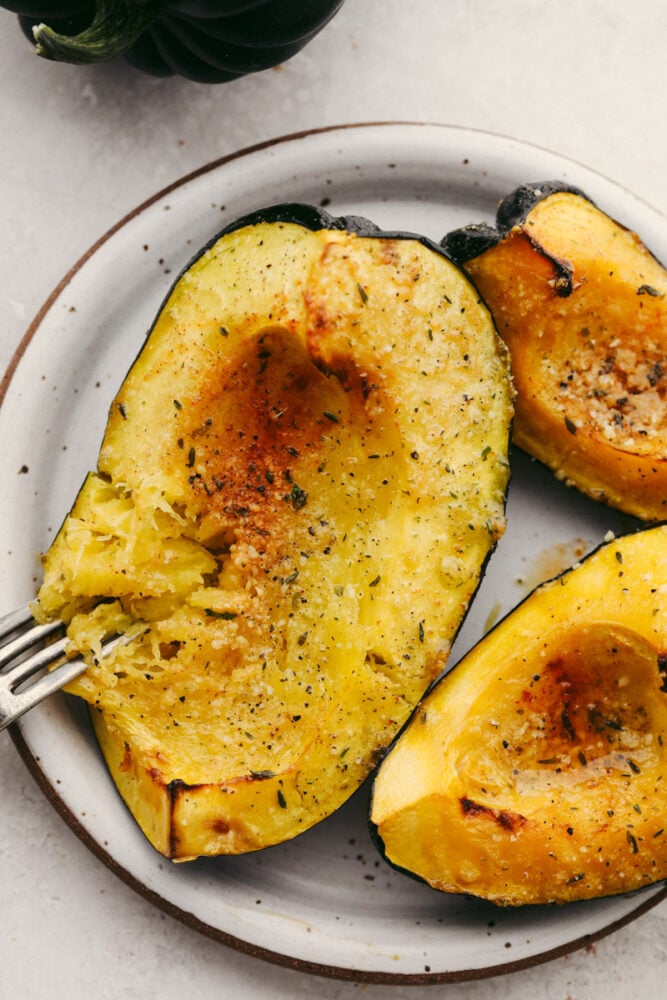 Roasted acorn squash with a fork.