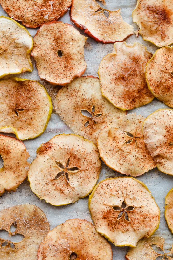 Baked apple chips on parchment. 