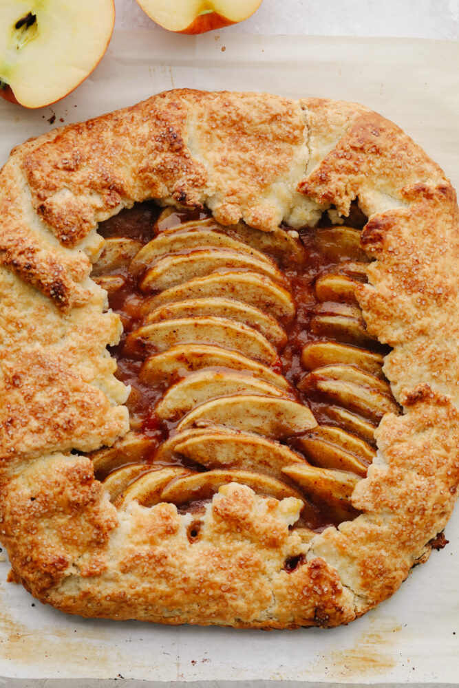 A full apple galette, topped with turbinado sugar.