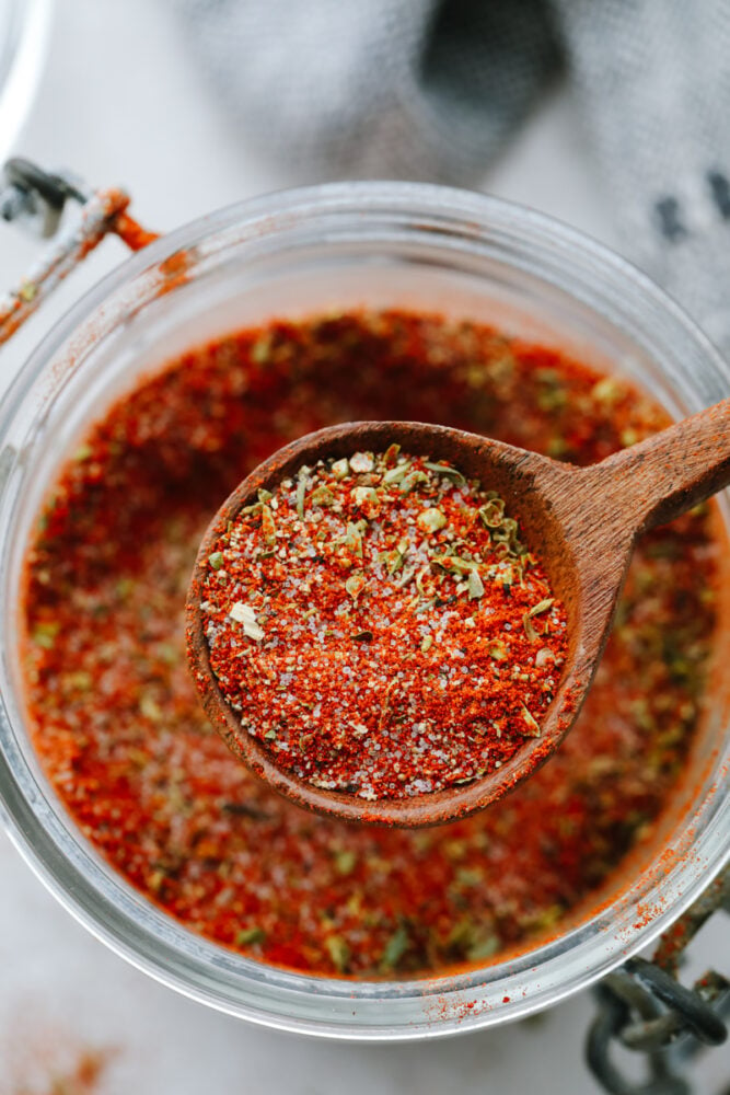 Close up of blackened seasoning with a wooden spoon. 