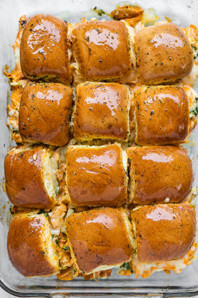 A pan of buffalo chicken sliders hot out of the oven.