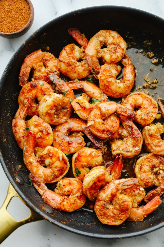 Cajun shrimp cooking in a pan. 