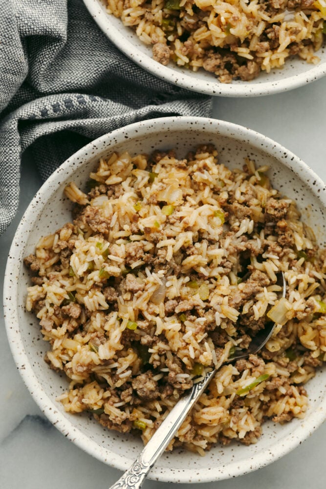 Dirty rice in a bowl with a spoon. 