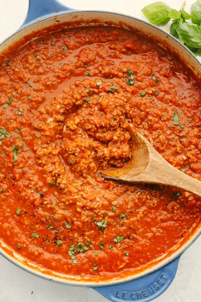 Bolognese sauce with a wooden spoon. 