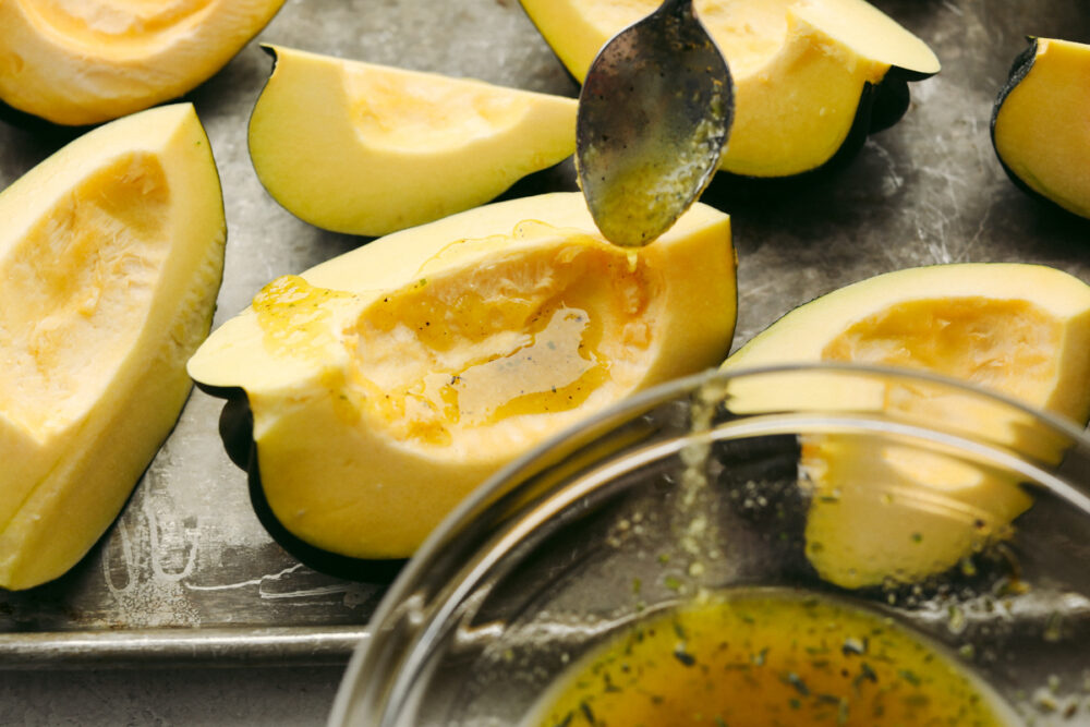 Sprinkle the oil and seasonings over the squash with a spoon. 