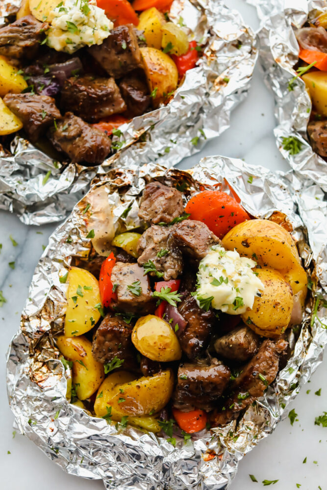 Steak and vegetables wrapped in foil. 