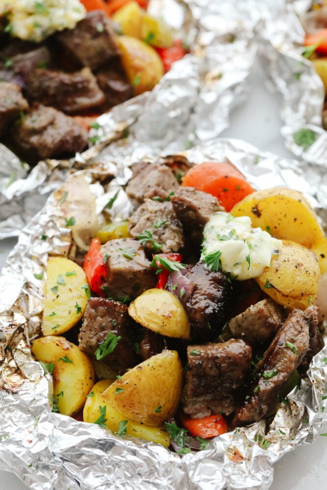 Close up of steak and vegetables in foil. 
