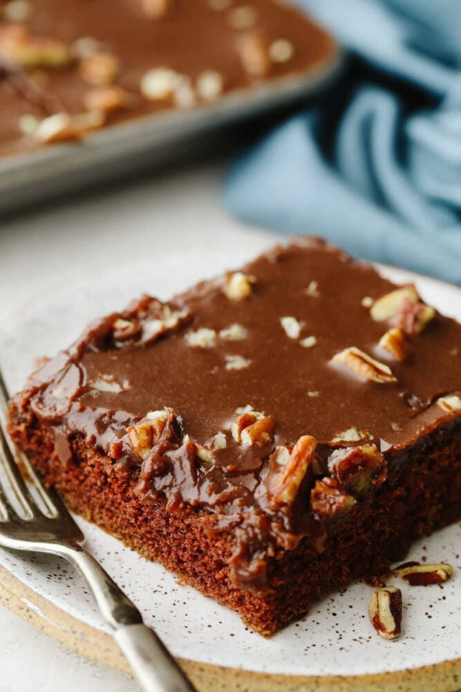 Texas sheet cake on a plate with a fork. 