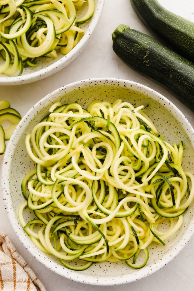 Front view of vegetable spiralizer making raw zucchini noodles