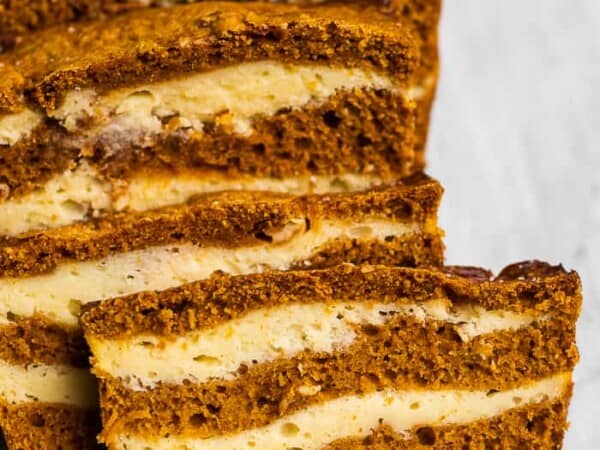 Slices of pumpkin bread with cream cheese swirls.
