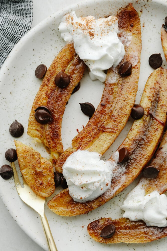 Baked bananas topped with cinnamon and whipped cream. 