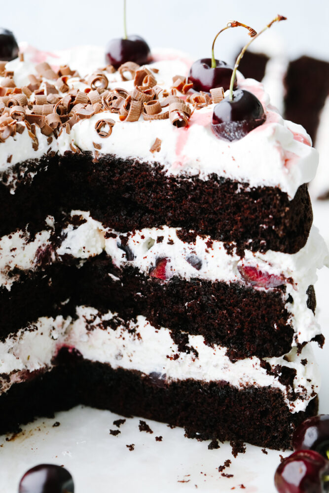 A black forest cake that has a slice taken out of it, showing the inside! 
