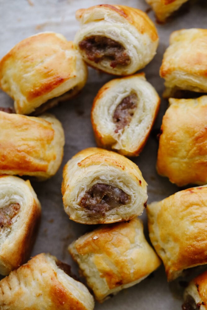 A sausage roll on a baking sheet. 