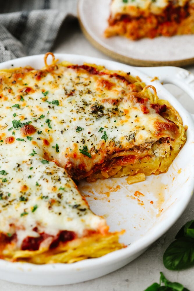 A spaghetti pie with a slice taken out of it.
