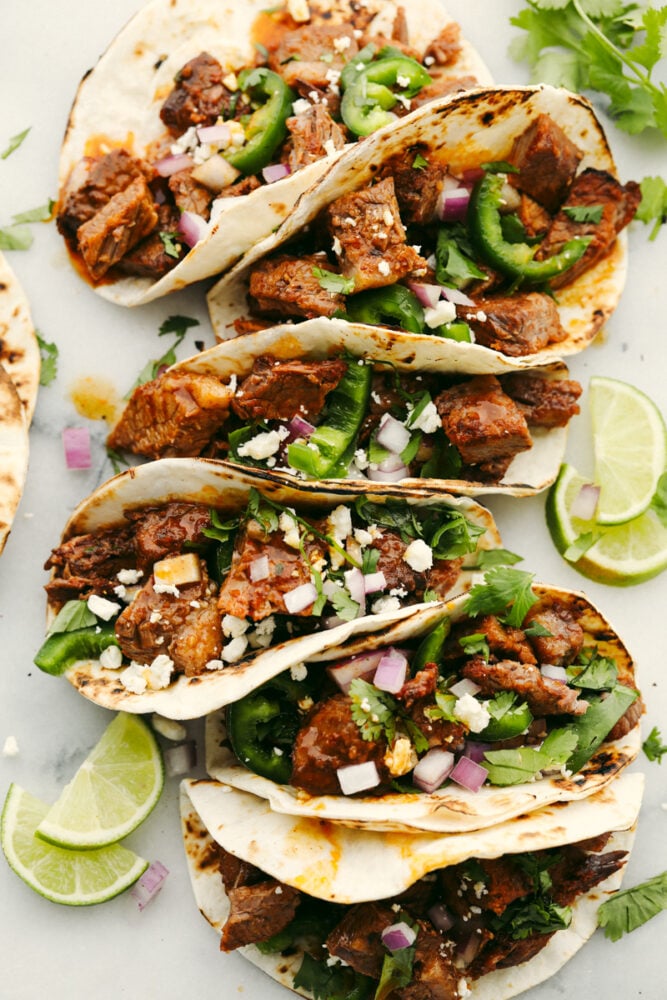 Beef brisket tacos with toppings in a tortilla. 