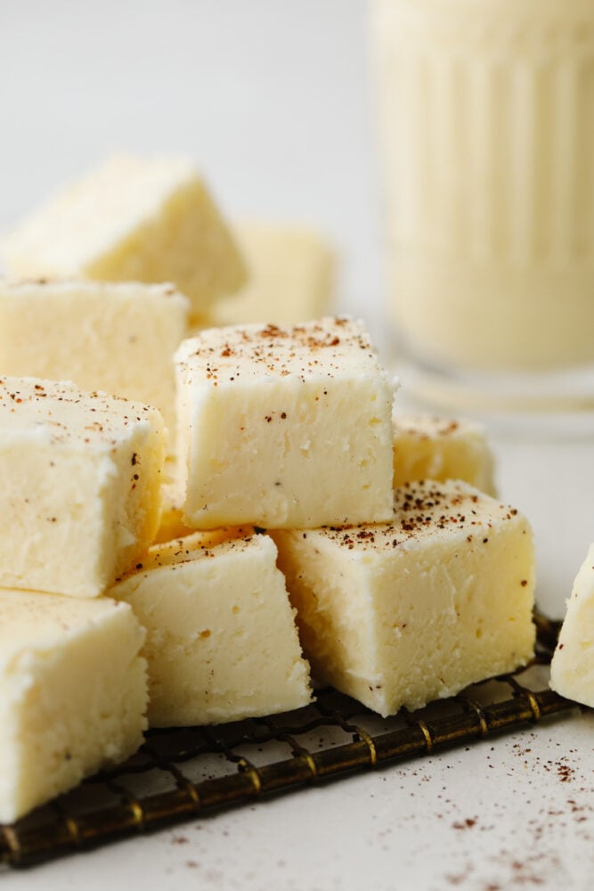 Cubes of eggnog fudge stacked on top of each other.