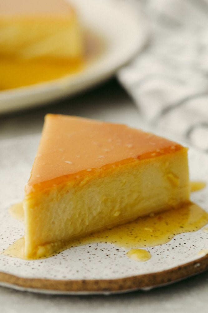 A slice of Flan cake on a white plate. 