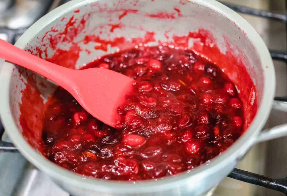 Cooking cranberries in a pan.