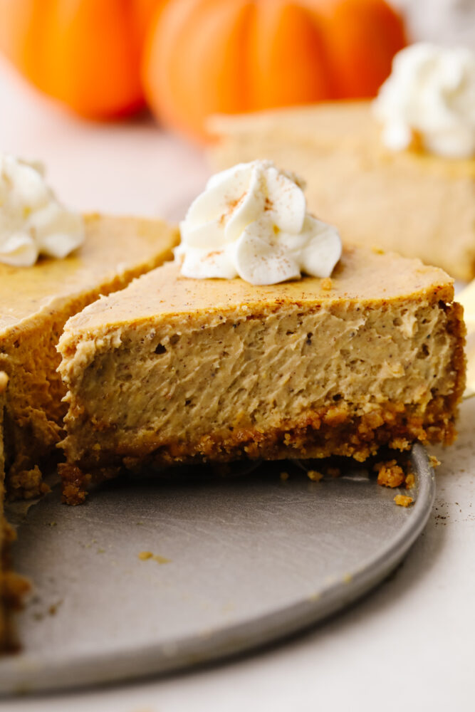 A side view of a slice of pumpkin cheesecake. 